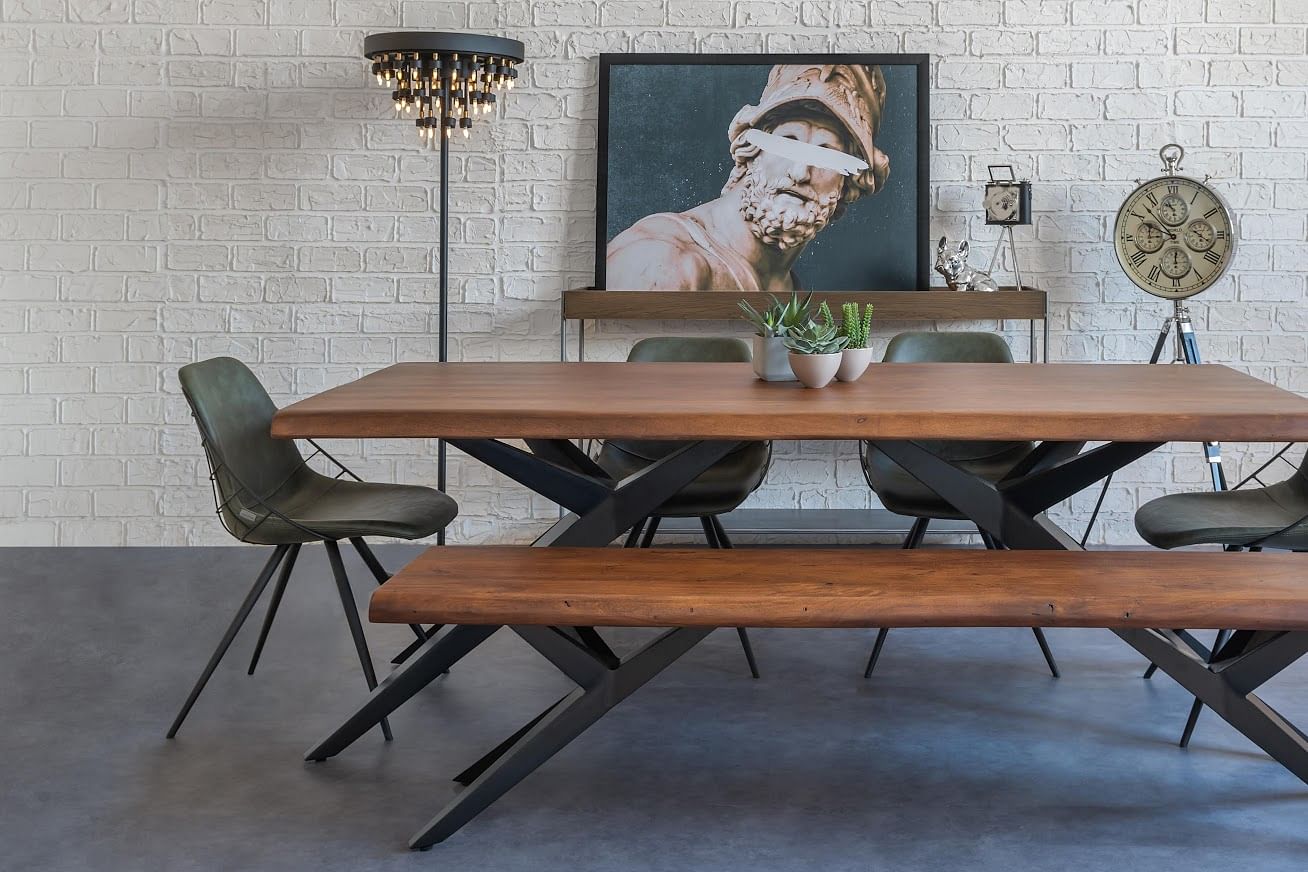 A quirky-modern dining room pairs wood and leather, characterful wall art, a retro standing clock, and chandelier floor lamp.