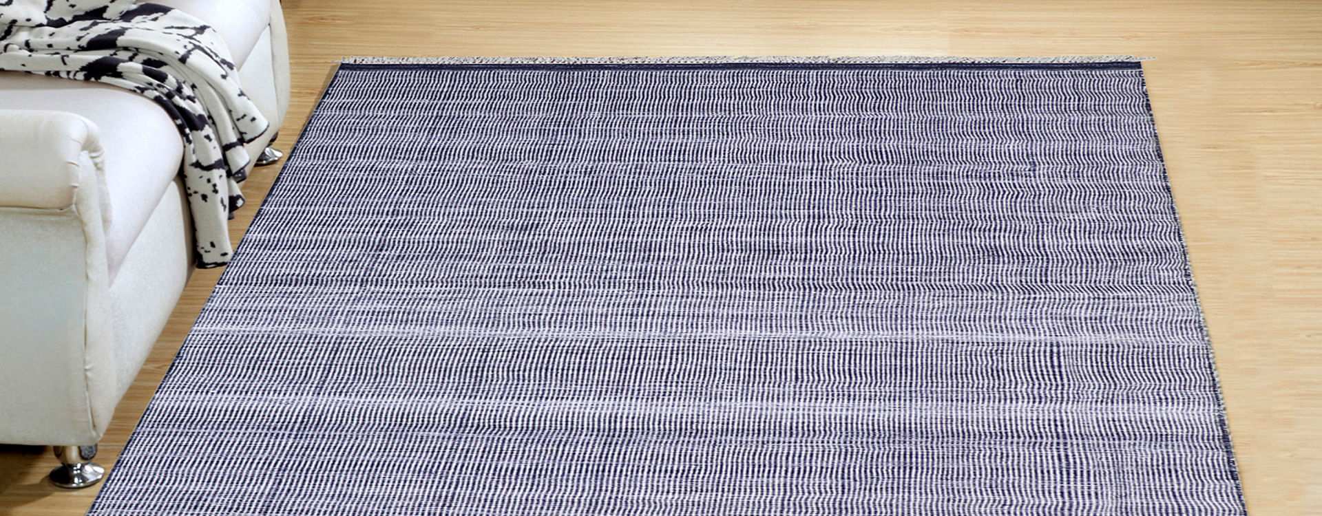 A rectangular blue rug with subtle lines