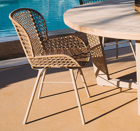 A durable DHPE resin and metal dining chair with a breathable rattan-inspired design 