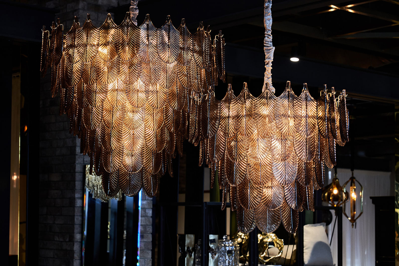 Two large brown pendant lights feature glass cut to look like leaves. 