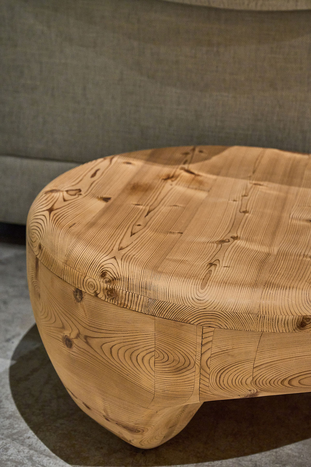 A chunky, all-wood round coffee table boasts caramel colours and natural grain.